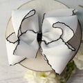 WHITE WITH BLACK HAIR BOW