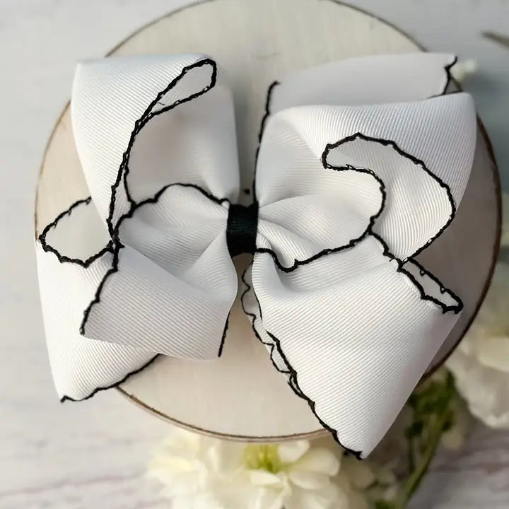 WHITE WITH BLACK HAIR BOW